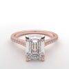 Cathedral setting emerald cut diamond with hidden halo ring with a simple prong setting in rose gold color and french paved diamonds band