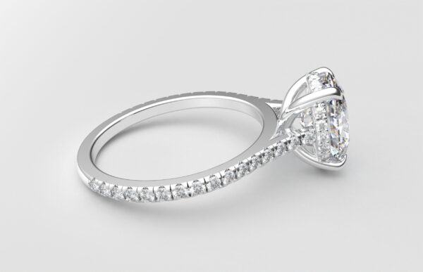 side view cathedral setting oval cut diamond with hidden halo ring with a simple prong setting in white gold color and french paved diamonds band