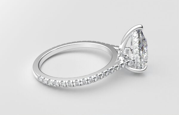 side view cathedral setting pear cut diamond with hidden halo ring with a simple prong setting in white gold color and french paved diamonds band