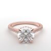 cathedral setting round cut diamond with hidden halo ring with a simple prong setting in rose gold color and french paved diamonds band