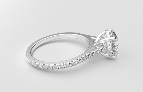 side view cathedral setting round cut diamond with hidden halo ring with a simple prong setting in white gold color and french paved diamonds band