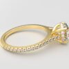 side view cathedral setting round cut diamond with hidden halo ring with a simple prong setting in yellow gold color and french paved diamonds band