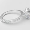 side view modern oval cathedral setting diamond with hidden halo ring with a classic prong setting in white gold color and french paved round diamonds band