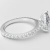 side view modern pear cathedral setting diamond with hidden halo ring with a classic prong setting in white gold color and french paved round diamonds band