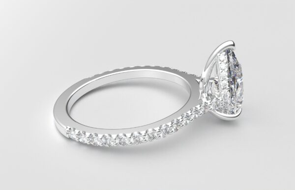 side view modern pear cathedral setting diamond with hidden halo ring with a classic prong setting in white gold color and french paved round diamonds band