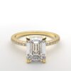 emerald diamond with hidden halo ring with a classic 4 prong setting in yellow gold color and french paved diamond band