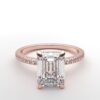 emerald diamond with hidden halo ring with a classic 4 prong setting in rose gold color and french paved diamond band