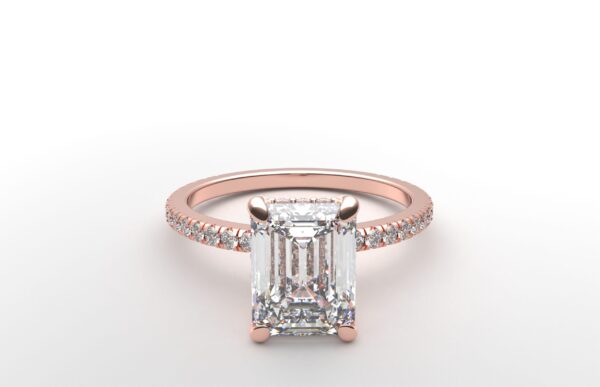 emerald diamond with hidden halo ring with a classic 4 prong setting in rose gold color and french paved diamond band