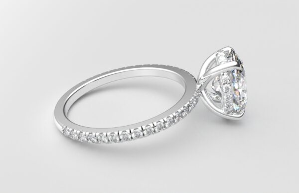 side view oval diamond with hidden halo ring with a classic 4 prong setting in white gold color and french paved diamond band