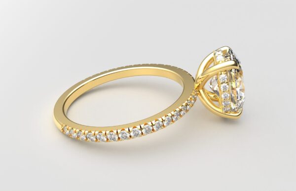 side view oval diamond with hidden halo ring with a classic 4 prong setting in yellow gold color and french paved diamond band