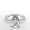 pear diamond with hidden halo ring with a classic 3 prong setting in white gold color and french paved diamond band