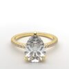 pear diamond with hidden halo ring with a classic 3 prong setting in yellow gold color and french paved diamond band