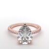 pear diamond with hidden halo ring with a classic 3 prong setting in rose gold color and french paved diamond band