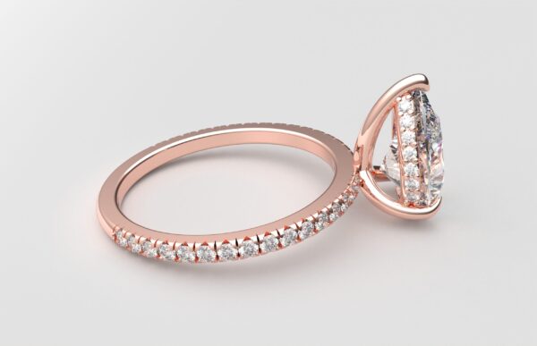 side view pear diamond with hidden halo ring with a classic 3 prong setting in rose gold color and french paved diamond band