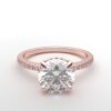 round diamond with hidden halo ring with a classic 4 prong setting in rose gold color and french paved diamond band