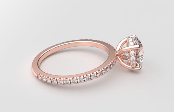 side view of round diamond with hidden halo ring with a classic 4 prong setting in rose gold color and french paved diamond band