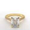 modern cathedral setting french pave emerald diamond ring in yellow gold with a hidden halo