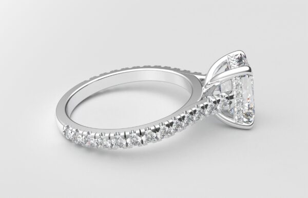 side view modern cathedral setting french pave emerald diamond ring in white gold with a hidden halo