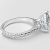 side view modern catherdral setting french pave pear diamond ring in white gold with a hidden halo