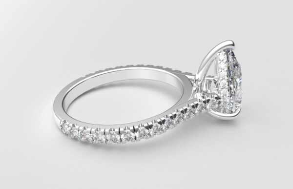 side view modern catherdral setting french pave pear diamond ring in white gold with a hidden halo