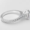 side view modern catherdral setting french pave round diamond ring in white gold with a hidden halo