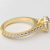 side view modern catherdral setting french pave round diamond ring in yellow gold with a hidden halo