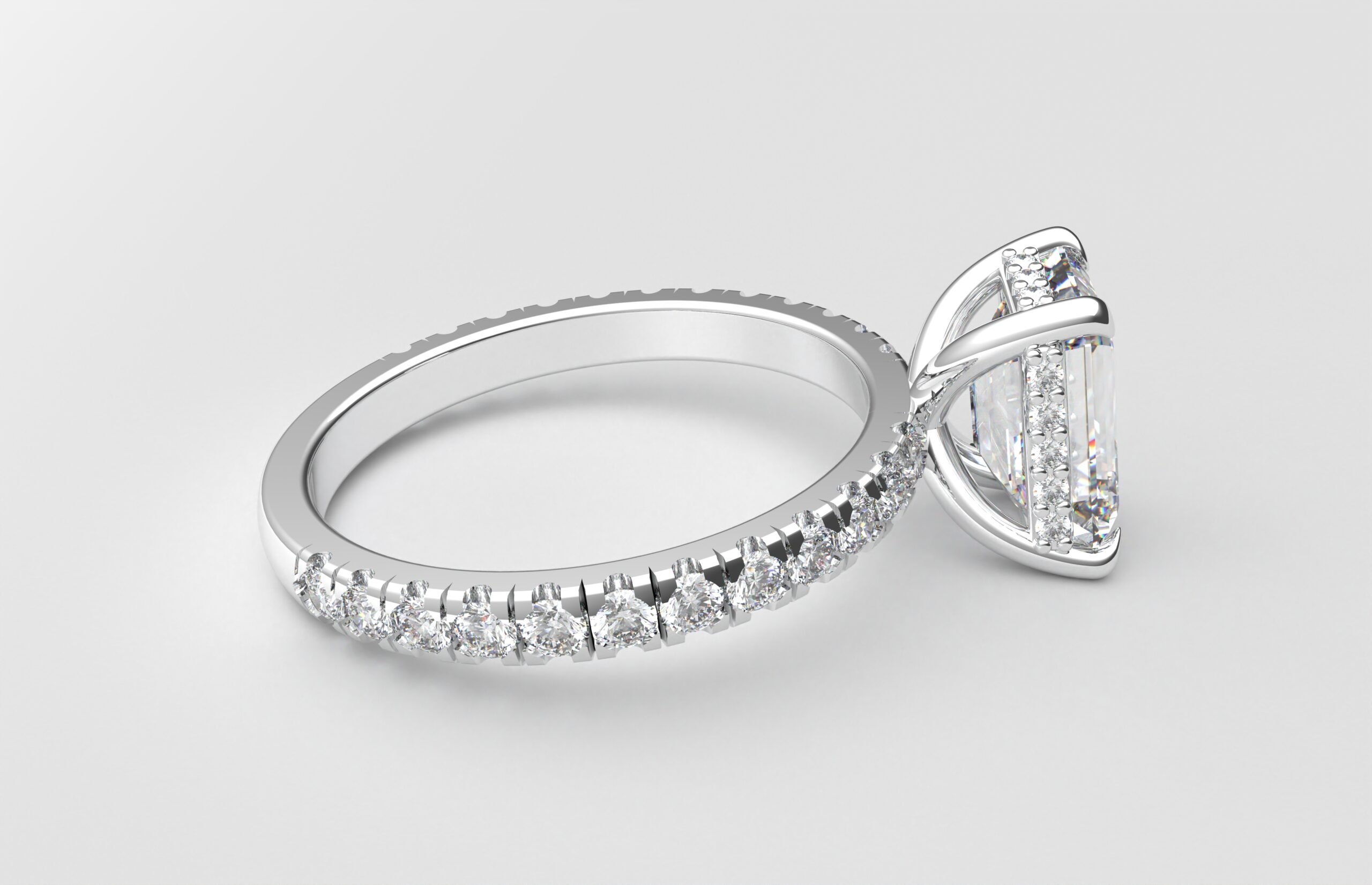 side view classic french pave emerald diamond ring in white gold with a hidden halo