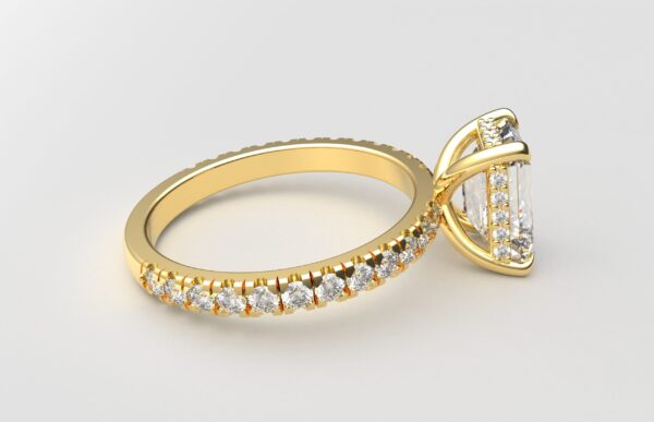 side view classic french pave emerald diamond ring in yellow gold with a hidden halo