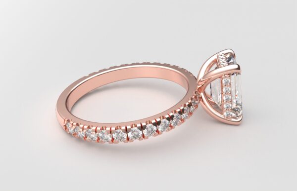 side view classic french pave emerald diamond ring in rose gold with a hidden halo