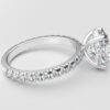 side view classic french pave oval diamond ring in white gold with a hidden halo