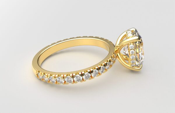 side view classic french pave oval diamond ring in yellow gold with a hidden halo