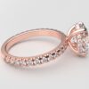 side view classic french pave oval diamond ring in rose gold with a hidden halo