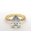 classic french pave pear diamond ring in yellow gold with a hidden halo