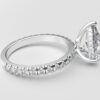 side view classic french pave pear diamond ring in white gold with a hidden halo