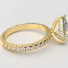 side view classic french pave pear diamond ring in yellow gold with a hidden halo