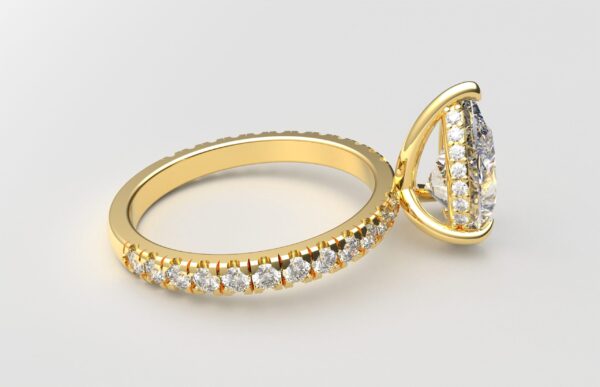 side view classic french pave pear diamond ring in yellow gold with a hidden halo