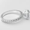 Side view classic french pave round diamond ring in white gold with a hidden halo