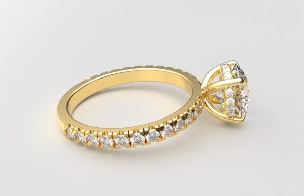 Side view classic french pave round diamond ring in yellow gold with a hidden halo