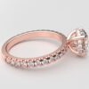 Side view classic french pave round diamond ring in rose gold with a hidden halo