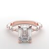 Emerald solitaire diamond ring in rose gold with round and marquise diamond band hidden halo