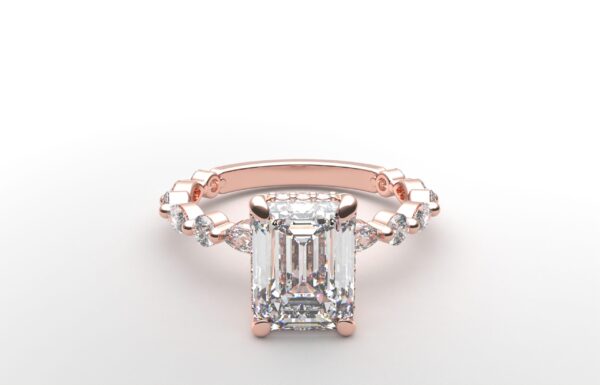 Emerald solitaire diamond ring in rose gold with round and marquise diamond band hidden halo