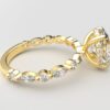 side view oval solitaire diamond ring in yellow gold with round and marquise diamond band hidden halo