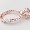 side view oval solitaire diamond ring in rose gold with round and marquise diamond band hidden halo