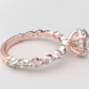 side view round solitaire diamond ring in rose gold with round and marquise diamond band hidden halo